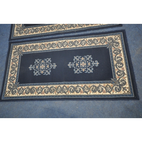 1272 - A PAIR OF BLUE GROUND RECTANGULAR RUGS, with foliate patterns, along with a nest of three tables (co... 