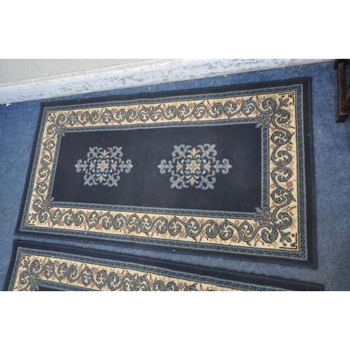 1272 - A PAIR OF BLUE GROUND RECTANGULAR RUGS, with foliate patterns, along with a nest of three tables (co... 