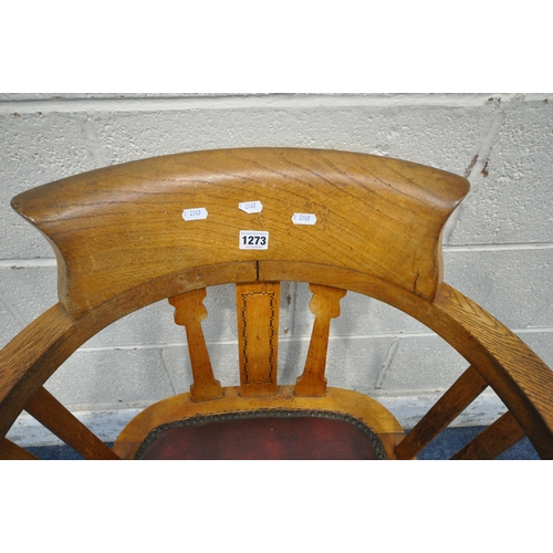 1273 - A 20TH CENTURY OAK OFFICE CHAIR, with swept armrests, oxblood leather seat pad, raised on four shape... 