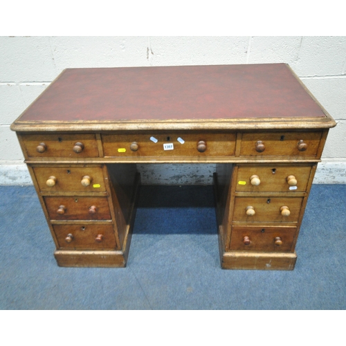 1307 - A 20TH CENTURY MAHOGANY TWIN PEDESTAL DESK, with burgundy leather writing surface, fitted with nine ... 