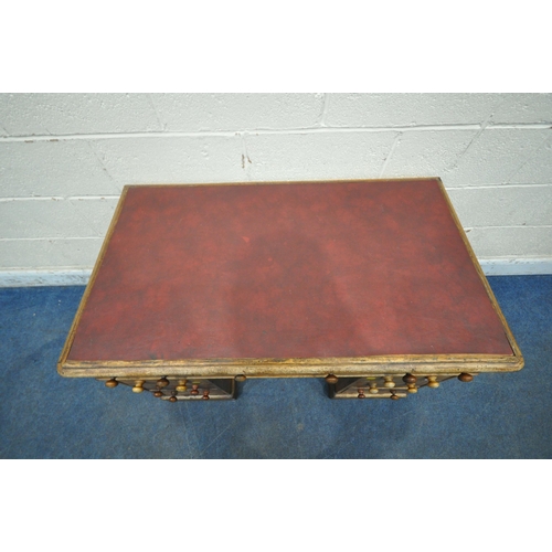 1307 - A 20TH CENTURY MAHOGANY TWIN PEDESTAL DESK, with burgundy leather writing surface, fitted with nine ... 