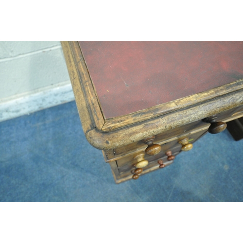 1307 - A 20TH CENTURY MAHOGANY TWIN PEDESTAL DESK, with burgundy leather writing surface, fitted with nine ... 