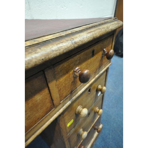 1307 - A 20TH CENTURY MAHOGANY TWIN PEDESTAL DESK, with burgundy leather writing surface, fitted with nine ... 