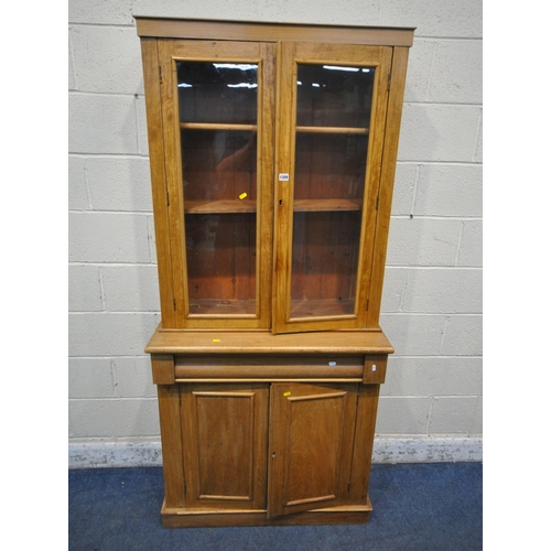 1309 - A 19TH CENTURY MAHOGANY BOOKCASE, with double glazed doors, atop a base with a single drawer, and do... 