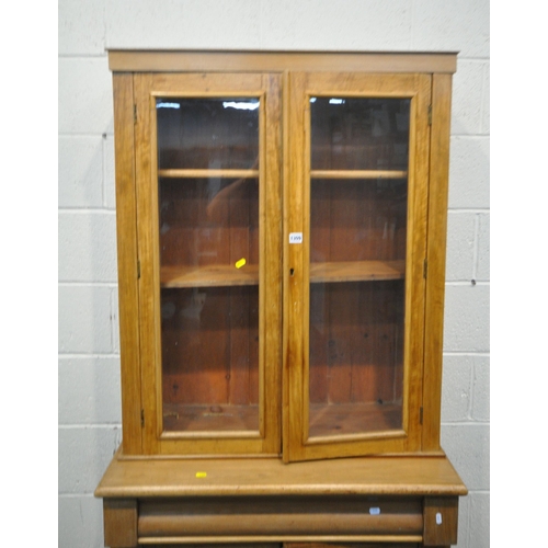 1309 - A 19TH CENTURY MAHOGANY BOOKCASE, with double glazed doors, atop a base with a single drawer, and do... 