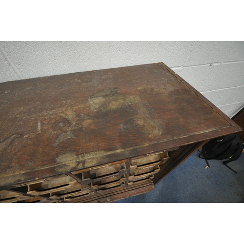 1314 - A 20TH CENTURY OAK FILING CABINET, with sixteen foolscap drawers, above two brushing slides and a fu... 