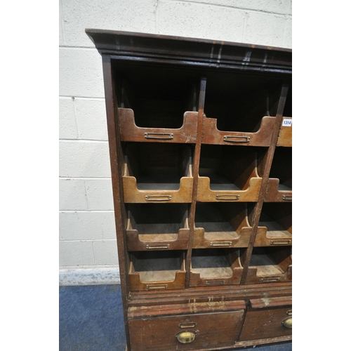 1314 - A 20TH CENTURY OAK FILING CABINET, with sixteen foolscap drawers, above two brushing slides and a fu... 