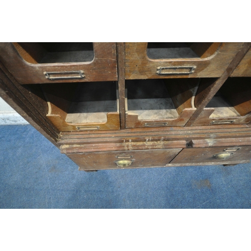 1314 - A 20TH CENTURY OAK FILING CABINET, with sixteen foolscap drawers, above two brushing slides and a fu... 