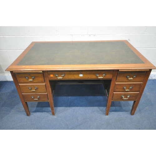 1317 - A 20TH CENTURY OAK KNEE HOLE DESK, with green leatherette writing surface, two brushing slides, eigh... 