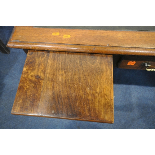 1317 - A 20TH CENTURY OAK KNEE HOLE DESK, with green leatherette writing surface, two brushing slides, eigh... 