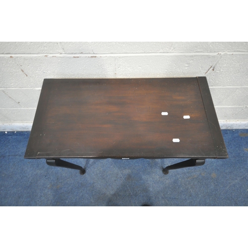 1320 - A 20TH CENTURY MAHOGANY TEA TABLE, the swivel fold over top enclosing a small storage section, a wav... 