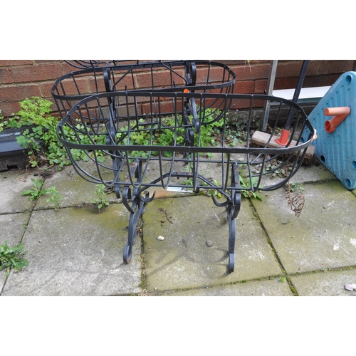 1005 - THREE MODERN WROUGHT IRON PLANTING BASKETS with scrolled legs, 60cm long and A32cm wide basket heigh... 