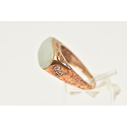 13 - A 9CT GOLD JADE RING, designed as an elongated oval jade panel within a collet setting to the scroll... 