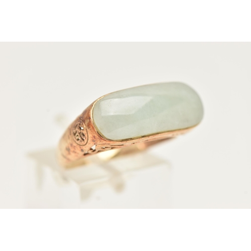 13 - A 9CT GOLD JADE RING, designed as an elongated oval jade panel within a collet setting to the scroll... 