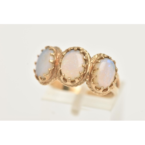 14 - A 9CT GOLD OPAL RING, designed as three oval opal cabochons within claw settings and outer rope twis... 