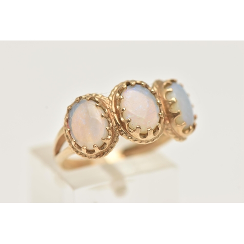 14 - A 9CT GOLD OPAL RING, designed as three oval opal cabochons within claw settings and outer rope twis... 