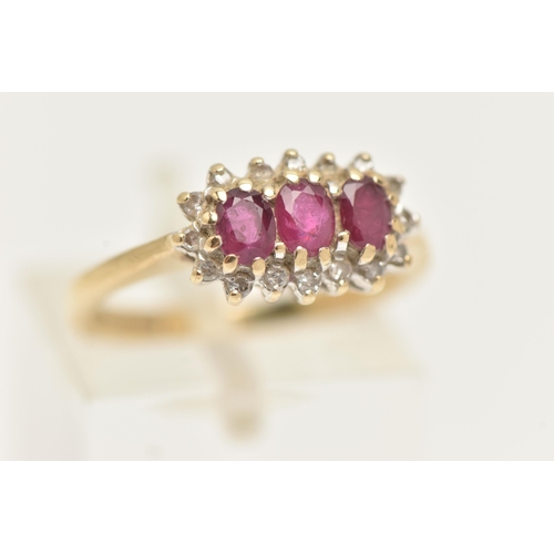 16 - A 9CT GOLD RUBY AND DIAMOND RING, designed as three oval cut rubies within a single cut diamond surr... 