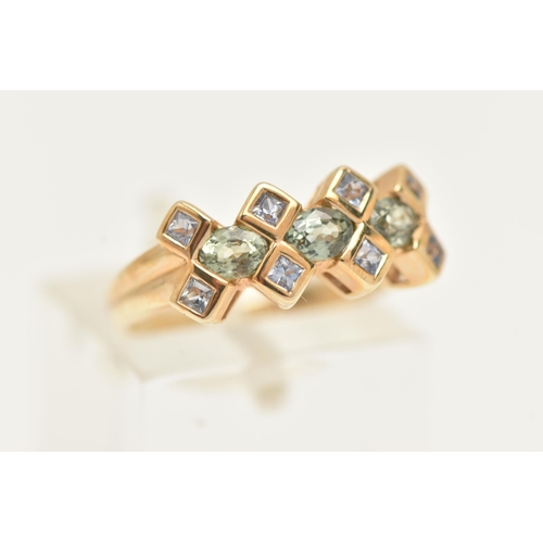 18 - A 9CT GOLD GEM SET RING, designed as a line of three oval cut green gems, assessed as green sapphire... 