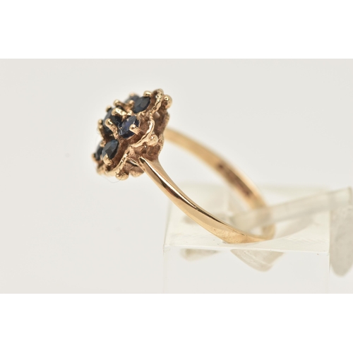 20 - A 9CT GOLD SAPPHIRE CLUSTER RING, designed as a cluster of circular cur sapphires within a shaped ro... 