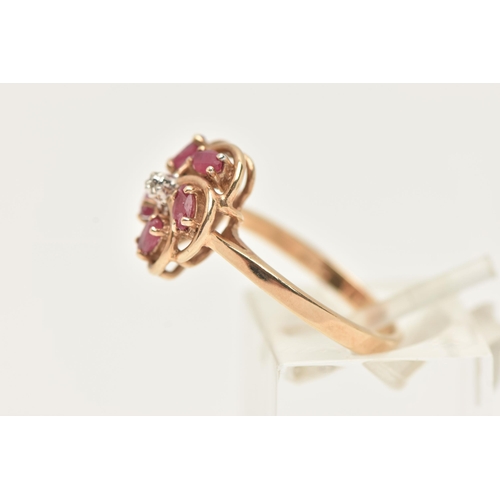 22 - A 9CT GOLD RUBY AND DIAMOND RING, designed as a central brilliant cut diamond, surrounded by marquis... 