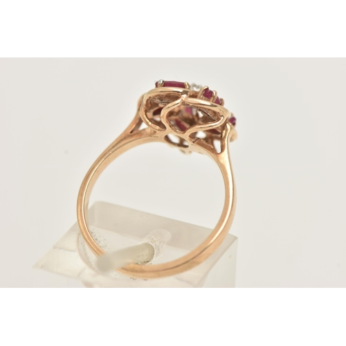 22 - A 9CT GOLD RUBY AND DIAMOND RING, designed as a central brilliant cut diamond, surrounded by marquis... 