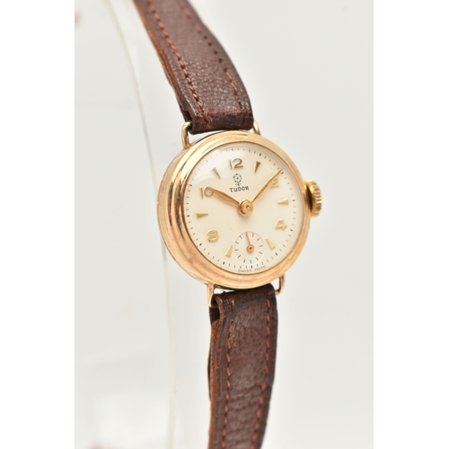 29 - A LADY'S TUDOR WATCH WITH 9CT GOLD HEAD, the white circular face with gold coloured Arabic numerals ... 