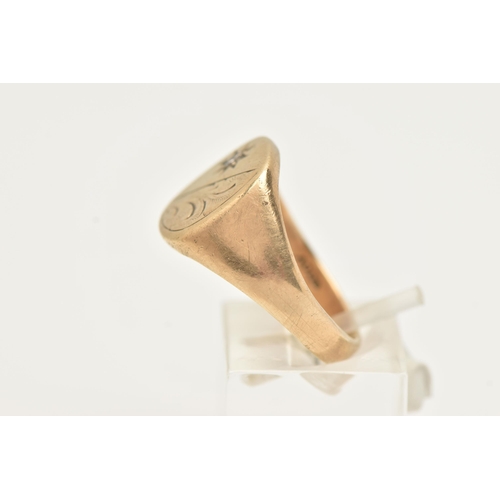 38 - A GENTS 9CT GOLD SIGNET RING, of a rounded form detailed with a foliate pattern and a star set round... 