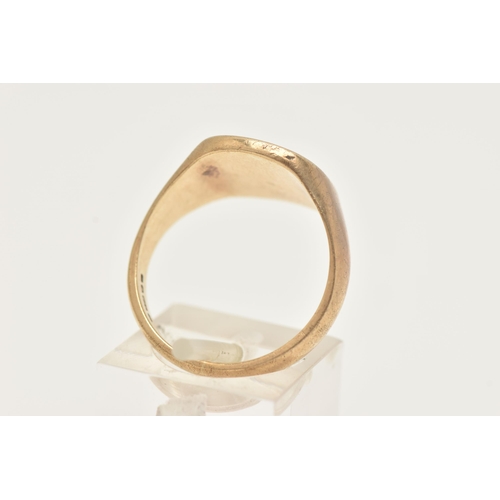 38 - A GENTS 9CT GOLD SIGNET RING, of a rounded form detailed with a foliate pattern and a star set round... 