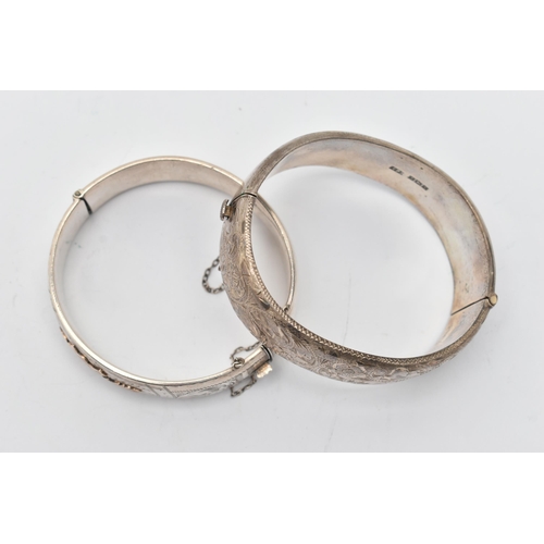 73 - TWO SILVER HINGED BANGLES, the first detailed with yellow metal thistles, fitted with an integrated ... 