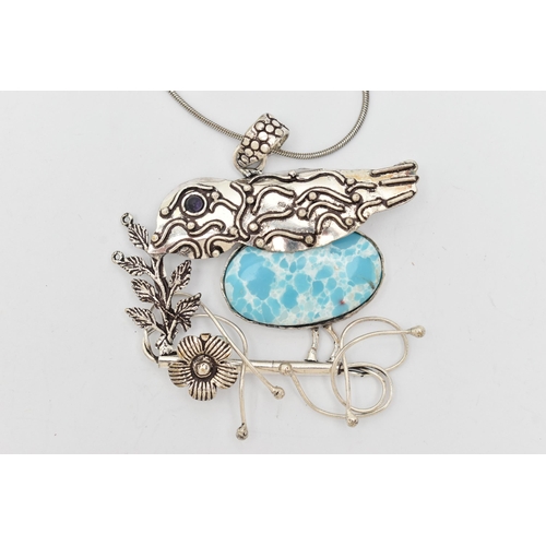 78 - A LARIMAR PENDANT, an oval cabochon larimar stone set in a white metal pendant, depicting a bird and... 