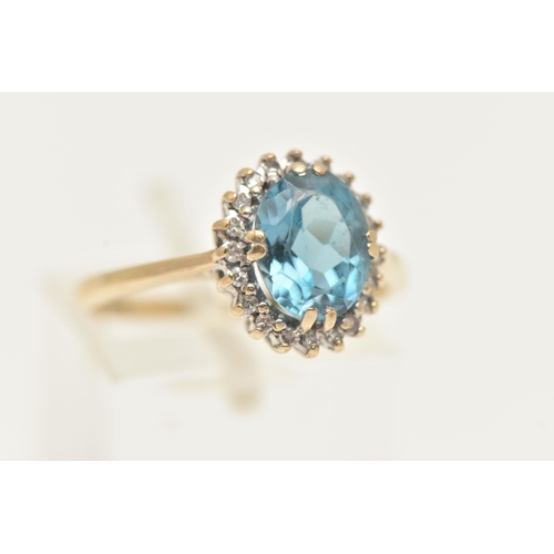 9 - A 9CT GOLD TOPAZ AND DIAMOND RING, designed as an oval blue topaz within a single cut diamond surrou... 