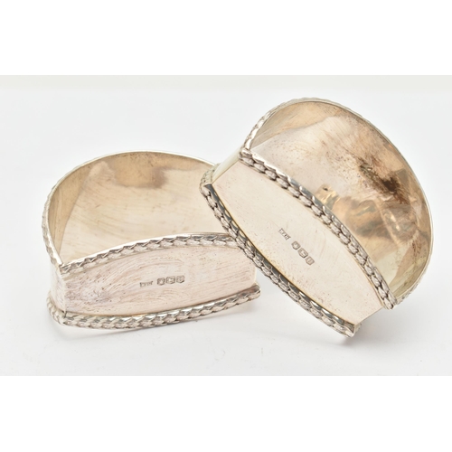 111 - A PAIR OF GEORGE V SILVER NAPKIN RINGS, a matching set of napkin rings with differing monogram detai... 