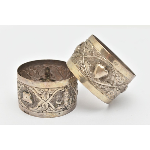 114 - A PAIR OF INDIAN WHITE METAL NAPKIN RINGS, not matching in design, one embossed with a repeating ani... 