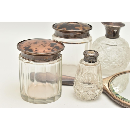 115 - AN ASSORTMENT OF SILVER LIDDED VANITY JARS AN A MIRROR, to include a cut glass scent bottle with a s... 