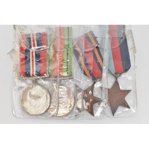 135 - FOUR MILITARY MEDALS, to include a pair of WWII war and defence medals and two star medals