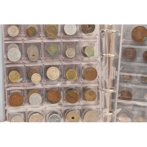 138 - A SMALL CARDBOARD BOX AND AN ALBUM OF WORLD COINS, some Silver content