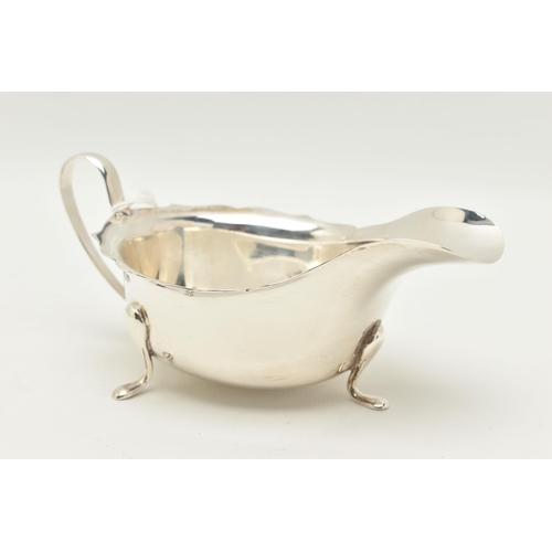 98 - A GEORGE V SILVER SAUCE BOAT, traditional design, with Chippendale style rim, a loop handle, raised ... 