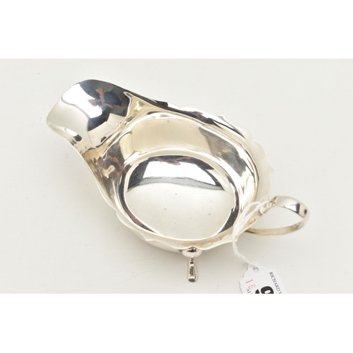 98 - A GEORGE V SILVER SAUCE BOAT, traditional design, with Chippendale style rim, a loop handle, raised ... 