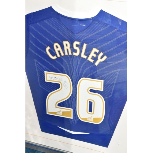 335 - TWO FRAMED AND GLAZED SIGNED BIRMINGHAM CITY HOME FOOTBALL SHIRTS, one signed by Lee Carsley, the ot... 