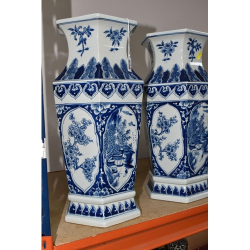 336 - TWO LARGE HEXAGONAL BLUE AND WHITE CHINESE VASES, decorated with pine trees, blossom and mountainsid... 