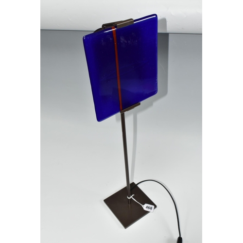 468 - A CLARISSE DUTRAIVE TABLE LAMP, with signed blue and red fused glass panel, on a metal stand, height... 