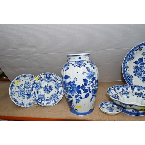 497 - A GROUP OF BLUE AND WHITE DELFT WARE CHARGERS AND VASE, comprising a floral design vase, height 26cm... 