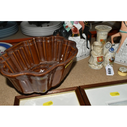 499 - A GROUP OF CERAMICS, comprising an early 20th century stoneware jelly mould, three pieces of crested... 