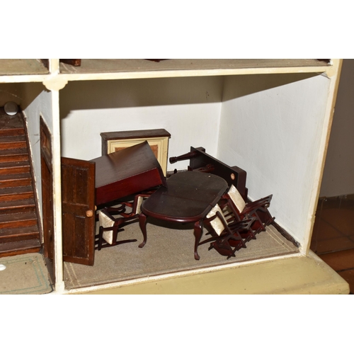 510 - A VINTAGE THREE-STOREY DOLLS HOUSE to include a nine room house with wooden dolls furniture, a magne... 