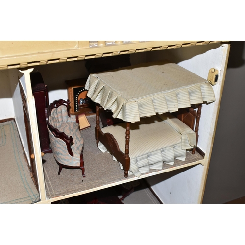 510 - A VINTAGE THREE-STOREY DOLLS HOUSE to include a nine room house with wooden dolls furniture, a magne... 