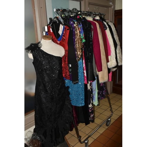 513 - A LARGE QUANTITY OF LADIES' EVENING DRESSES, FAUX FUR JACKETS, AND TOPS to include a vintage purple ... 