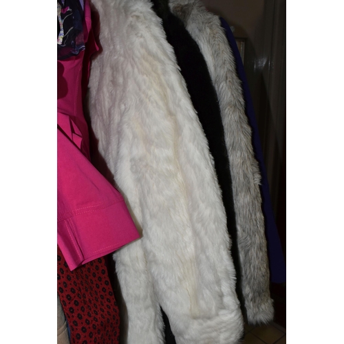 513 - A LARGE QUANTITY OF LADIES' EVENING DRESSES, FAUX FUR JACKETS, AND TOPS to include a vintage purple ... 