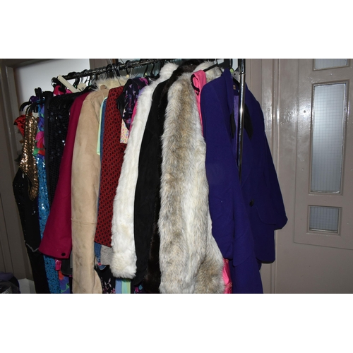 513 - A LARGE QUANTITY OF LADIES' EVENING DRESSES, FAUX FUR JACKETS, AND TOPS to include a vintage purple ... 