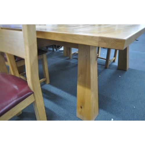 1195 - A LARGE SQUARE OAK DINNG TABLE, raised on thick square tapered legs, 180cm squared x height 78cm, al... 