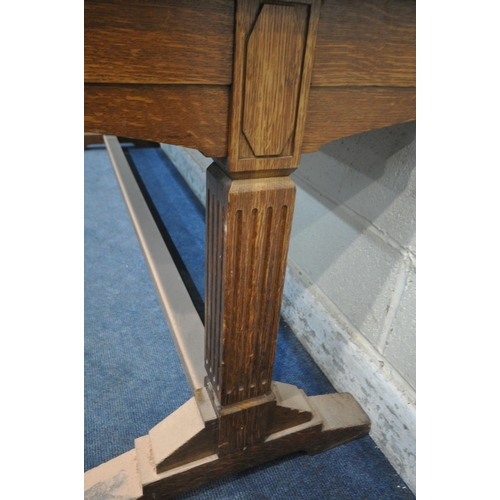 1196 - IN THE MANNER OF A.W.N PUGIN, A 20TH CENTURY OAK SLIM LIBRARY TABLE, with a green leather writing su... 